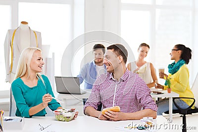 Smiling fashion designers having lunch at office Stock Photo