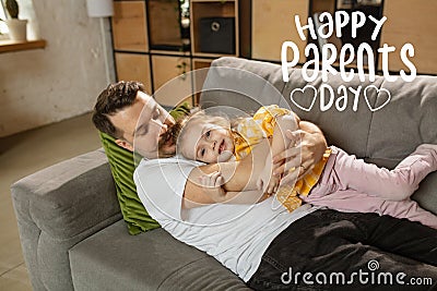 Smiling father and little cute daughter at home. Family time, togehterness, parenting and happy childhood concept Stock Photo