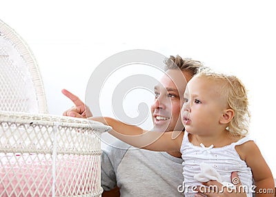 Smiling father showing baby daughter crib Stock Photo