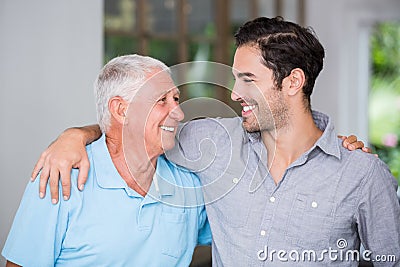 Smiling father and son with arm around Stock Photo