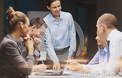 Smiling female boss talking to business team Stock Photo