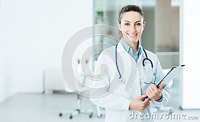 Smiling female doctor holding medical records Stock Photo