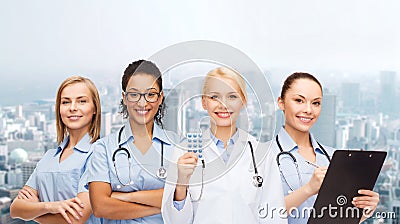 Smiling female doctor and nurses with stethoscope Stock Photo