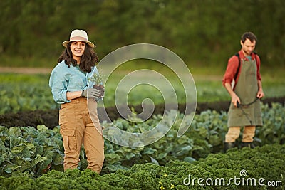 Smiling Female Farmer Working in Plantation Stock Photo