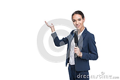 smiling female newscaster with microphone presenting something, Stock Photo