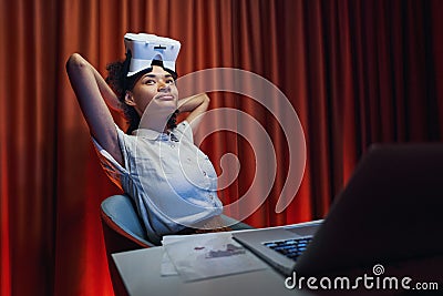 American woman is spending time at workplace Stock Photo