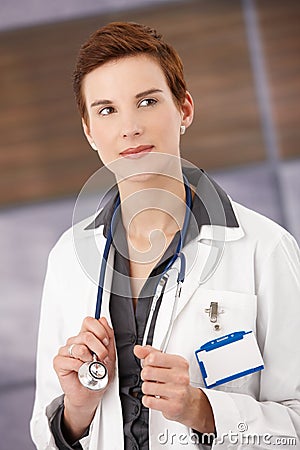 Smiling female physician in smock Stock Photo