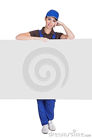 Smiling Female Plumber Holding Placard Stock Photo