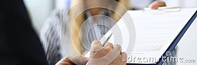 Smiling female real estate agent offering male visitor document to sign Stock Photo