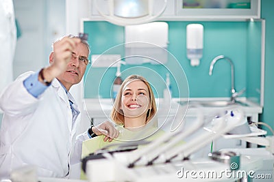 Smiling female woman with dentist looking at dental snapshot Stock Photo