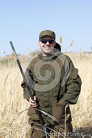 Smiling fisherman on field Stock Photo