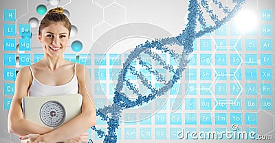Smiling fit woman holding weight machine by DNA structure Stock Photo