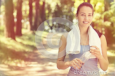 Smiling fit woman with white towel resting after sport exercises Stock Photo