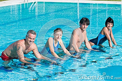 Smiling fitness people exercising in swimming pool Stock Photo