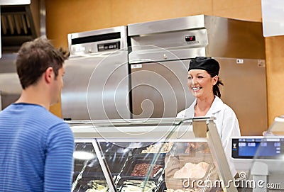 Smiling food retailer with a male customer Stock Photo