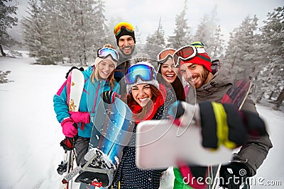 Smiling friends with ski on winter holidays - Skiers having fun Stock Photo