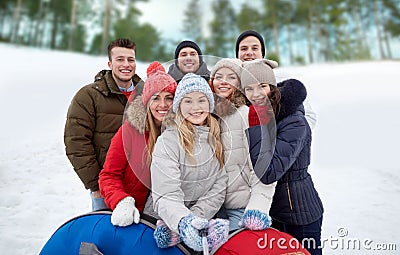 Smiling friends with snow tubes and selfie stick Stock Photo