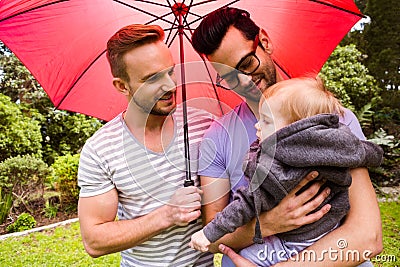 Smiling gay couple with child Stock Photo