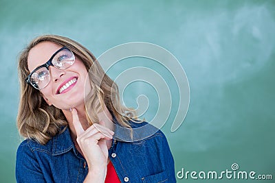 Smiling geeky teacher standing in front of blackboard Stock Photo