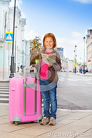 Smiling girl alone on the street with city map Stock Photo