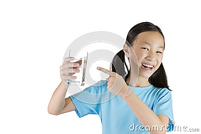 Smiling girl,Asian gril holding a glass of water isolated on white background,Life canâ€™t live without drinking water. Stock Photo