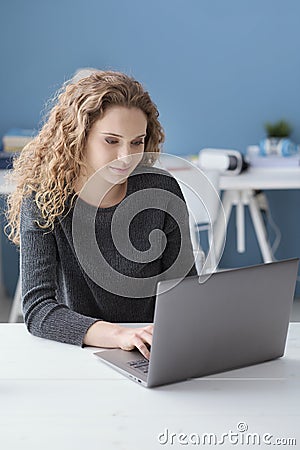 Smiling girl connecting with her laptop Stock Photo