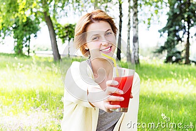 Smiling girl drinks juice Stock Photo