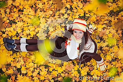 Smiling girl in gold autumn leaves Stock Photo