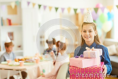 Smiling Girl Holding Birthday Presents Stock Photo