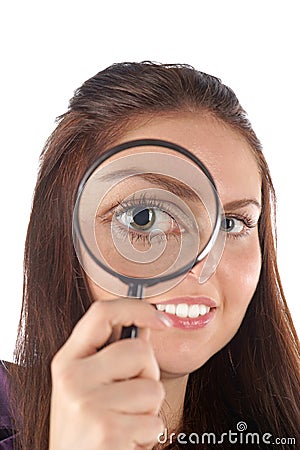Smiling girl looking through magnifying glass Stock Photo