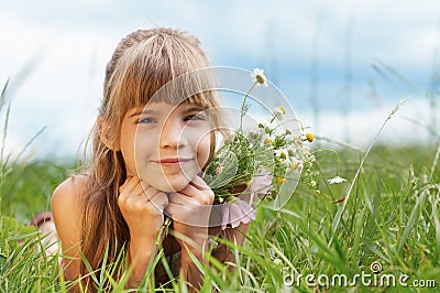 Smiling girl lying on grass Stock Photo