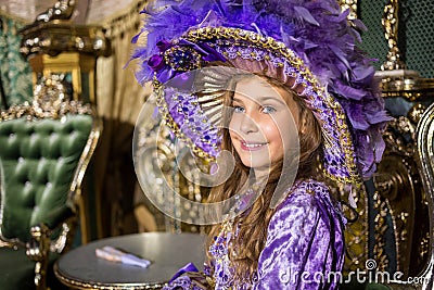 The smiling girl in old-fashione dress and hat in Stock Photo