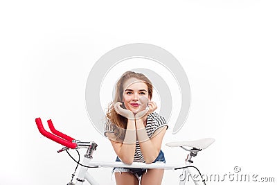 Smiling girl posing on bicycle Stock Photo