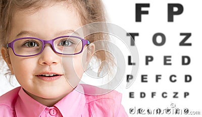 Smiling girl putting on glasses with blurry eye Stock Photo