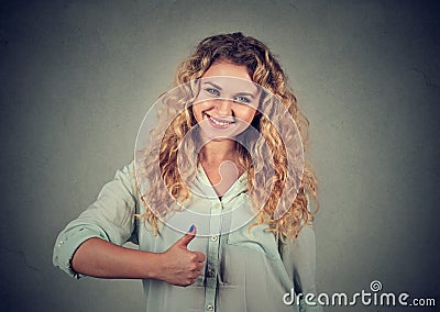 Smiling girl raises right thumb up Stock Photo