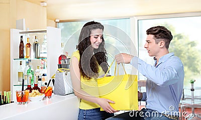 Smiling girl receiving a gift from her boyfriend Stock Photo