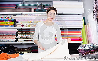 Seller showing white fabric Stock Photo
