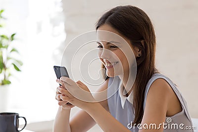 Happy girl feel excited messaging using smartphone Stock Photo