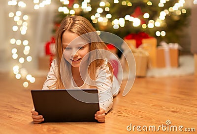 Smiling girl with tablet pc at christmas home Stock Photo