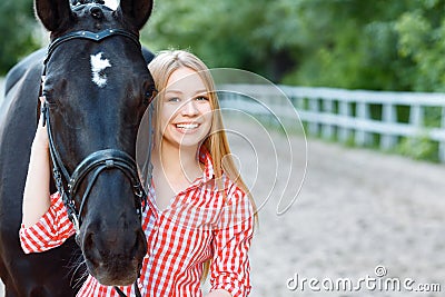 Smiling girl taking care of the horse Stock Photo