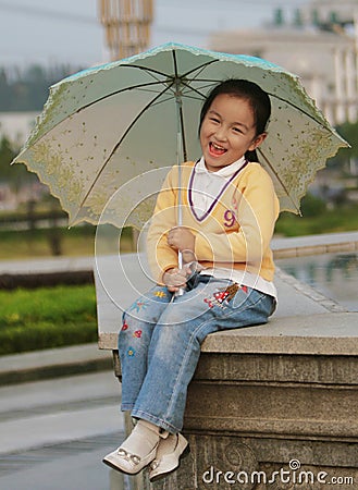 Smiling girl with a umbrella Stock Photo