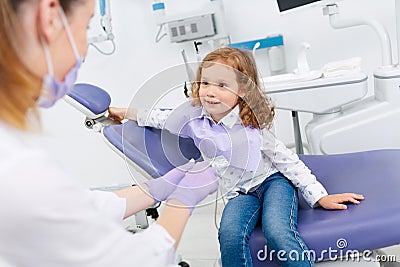 Smiling girl visiting dentist Stock Photo