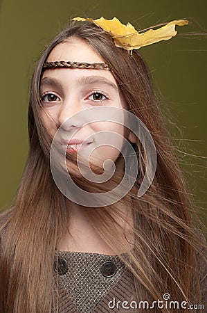 Smiling girl wearing yellow leaves in her hair Stock Photo