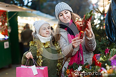 Smiling girl with woman are buying Christmas ornamentals Stock Photo