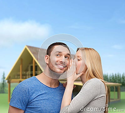 Smiling girlfriend telling boyfriend secret Stock Photo