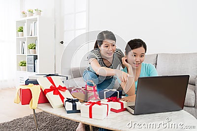 Smiling girlfriends looking at mobile computer Stock Photo