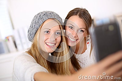 Smiling girlfriends taking selfie Stock Photo