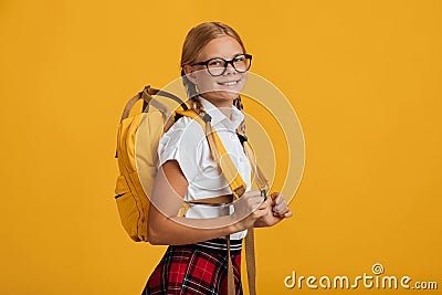 Smiling glad clever european teenager girl student in glasses with pigtails and backpack look at camera Stock Photo