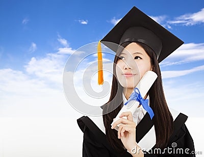 Graduate woman Holding Degree with cloud background Stock Photo