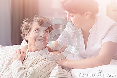 Smiling granddaughter hugging happy grandmother during family meeting Stock Photo